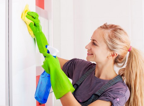 Cleaner preparing a safe workspace before starting a cleaning task