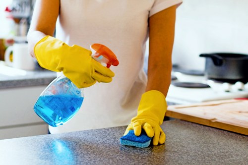Cleaner wearing PPE while working safely in a Marylebone property