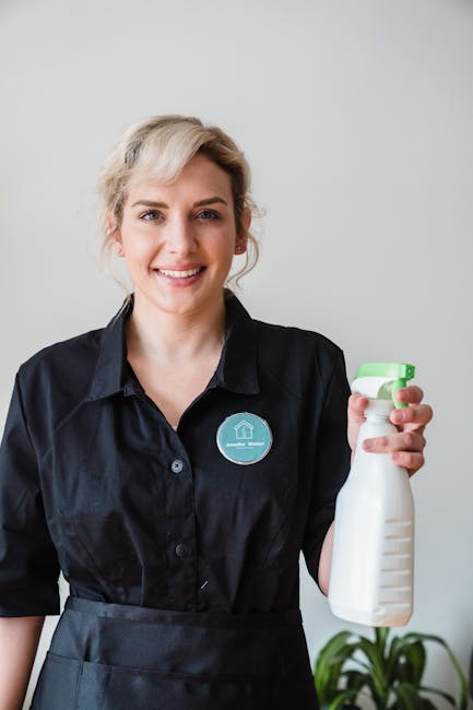 Three domestic cleaners from Marylebone Cleaner are performing surface cleaning and deep cleaning tasks in a modern living room. The room features a tiled floor that appears clean and shiny, with a la